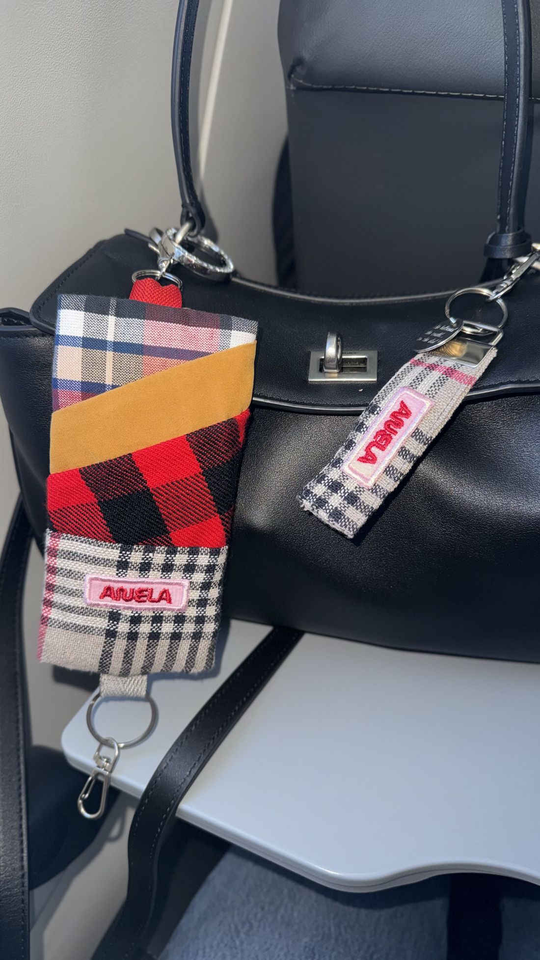 ANELA patchwork keychain on a leather bag
